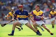 11 August 2002; John Boland of Tipperary in action against Richard Flynn of Wexford during the All-Ireland Minor Hurling Championship Semi-Final match between Wexford and Tipperary at Croke Park in Dublin. Photo by Brian Lawless/Sportsfile