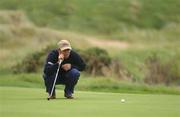 15 August 2002; Andrew Coltart lines up a putt on the 18th green during day one of the North West of Ireland Open at Ballyliffin Golf Club, Glasheby Links, in Donegal. Photo by Matt Browne/Sportsfile