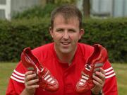 22 August 2002; Cork footballer Colin Corkery in the grounds of Jury's hotel in Cork. Colin is switching from his champagne Adidas predators to Metallic Red/Silver Adidas Predator Mania's for Sunday's Bank of Ireland All-Ireland Senior Football Championship Semi-Final clash with Kerry. Corkery is hoping to raise more money for the childrens Unit of Cork University College Hospital by auctioning the boots after the game. Photo by Damien Eagers/Sportsfile