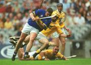 28 July 2002; John Carroll of Tipperary is tackled by Ciaran Herron, yellow helmet, and Kieran Kelly of Antrim during the All-Ireland Senior Hurling Championship Quarter-Final match between Antrim and Tipperary at Croke Park in Dublin. Photo by Aoife Rice/Sportsfile