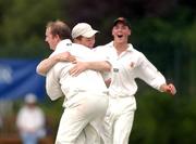 23 August 2002; Damien Ryan Malahide, left, is congratulated by team-mates Eoin Morgan and Peter Saville after trapping Naseer Shukat of Rush, LBW during the Royal Liver Irish Senior Cricket Cup Final match between Malahide and Rush at Clontarf Cricket Club in Dublin. Photo by David Maher/Sportsfile