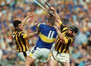 18 August 2002; John Carroll of Tipperary in action against Philip Larkin, left, and Noel Hickey of Kilkenny during the Guinness All-Ireland Senior Hurling Championship Semi-Final match between Kilkenny and Tipperary at Croke Park in Dublin. Photo by Damien Eagers/Sportsfile