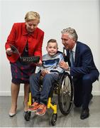 22 August 2017; Tánaiste Frances Fitzgerald TD, left, and FAI Chief Executive John Delaney, right, look at the Football For All booklet with James Casserly, aged 11, from Lucan, Co. Dublin during the Football For All Strategic Plan Launch at the Marker Hotel in Dublin. Photo by David Fitzgerald/Sportsfile