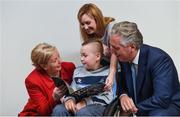 22 August 2017; Tánaiste Frances Fitzgerald TD, left, and FAI Chief Executive John Delaney, right, look at the Football For All booklet with James Casserly, aged 11, from Lucan, Co. Dublin and his mother Vicky Casserly during the Football For All Strategic Plan Launch at the Marker Hotel in Dublin. Photo by David Fitzgerald/Sportsfile