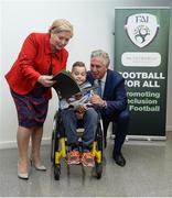 22 August 2017; Tánaiste Frances Fitzgerald TD, left, and FAI Chief Executive John Delaney, right, look at the Football For All booklet with James Casserly, age 11, from Lucan, Co. Dublin during the Football For All Strategic Plan Launch at the Marker Hotel in Dublin.  Photo by Cody Glenn/Sportsfile