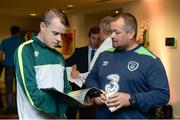 22 August 2017; James Conroy, left, Irish Amputee Football team goalkeeper, reads the Football For All Strategy booklet with Chris McElliott, FAI Community Coach, during the Football For All Strategic Plan Launch at the Marker Hotel in Dublin.  Photo by Cody Glenn/Sportsfile