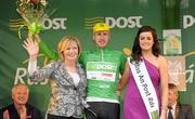 21 May 2012; Gediminas Bagdonas, An Post Sean Kelly team, is presented with his An Post points leader green jersey by Noelle Piggott, Postmistress Gort Post Office, and Miss An Post Rás Gort Orla Ruane following the second stage of the 2012 An Post Rás. Kilkenny - Gort. Picture credit: Stephen McCarthy / SPORTSFILE
