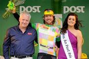 21 May 2012; Dan Cravan, Sigma Sport, is presented with his One4All King of the Mountains jersey by Eamonn Dawson, Head of Business Development, and Miss An Post Rás Gort Orla Ruane following the second stage of the 2012 An Post Rás. Kilkenny - Gort. Picture credit: Stephen McCarthy / SPORTSFILE