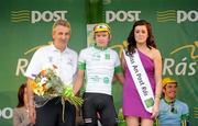 21 May 2012; Richard Handley, Rapha Condor Sharp, is presented with his Irish Sports Council U23 white jersey by Mick Curley, Galway Sports Partnership Co-ordinator and Miss An Post Rás Gort Orla Ruane following the second stage of the 2012 An Post Rás. Kilkenny - Gort. Picture credit: Stephen McCarthy / SPORTSFILE