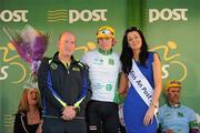 25 May 2012; Richard Handley, Rapha Condor Sharp, is presented with his Irish Sports Council leading U23 rider jersey by Myles Sweeney, Co-ordinator, Donegal Local Sports Partnership, and Miss An Post Rás Killybegs Ailbhe Cunningham following the sixth stage of the 2012 An Post Rás. Buncrana - Killybegs. Picture credit: Stephen McCarthy / SPORTSFILE