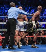26 August 2017; Referee Robert Byrd separates Floyd Mayweather Jr, right, from Conor McGregor after calling an end to the welterweight boxing match between Floyd Mayweather Jr v Conor McGregor at T-Mobile Arena in Las Vegas, USA. Photo by Stephen McCarthy/Sportsfile