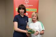 26 May 2012; Fionnuala Treacy, from Ahascragh, Co Galway, is presented with an FAI International Cap after representing the Republic of Ireland in the 2010 Special Olympics European Games by Olivia O'Toole, herself a Republic of Ireland star, during the 2012 Special Olympics Ireland AGM. Red Cow Moran Hotel, Naas Road, Dublin. Picture credit: Ray McManus / SPORTSFILE