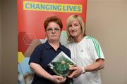 26 May 2012; Catherine McCarthy, from Cashel, Co. Tipperary, is presented with an FAI International Cap after representing the Republic of Ireland in the 2010 Special Olympics European Games by Olivia O'Toole, herself a Republic of Ireland star, during the 2012 Special Olympics Ireland AGM. Red Cow Moran Hotel, Naas Road, Dublin. Picture credit: Ray McManus / SPORTSFILE