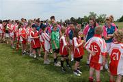 26 May 2012; Players on the 2011 All Stars team, including Aisling Holton, Kildare, Geraldine O'Flynn, Cork, Aisling Leonard, Kerry, and Briege Corkery, Cork, engage with the local mascots before the game. 2012 TG4/O'Neills Ladies All-Star Tour Exhibition Game, 2010 All Stars v 2011 All Stars, Centennial Park, Toronto, Canada. Picture credit: Brendan Moran / SPORTSFILE