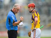 2 June 2012; Referee John Sexton explains to Wexford's Willie Deveraux his reason for issuing a yellow card. Leinster GAA Hurling Senior Championship Quarter-Final, Offaly v Wexford, O'Connor Park, Tullamore, Co. Offaly. Picture credit: Ray McManus / SPORTSFILE