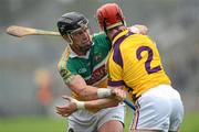 2 June 2012; Offaly's Shane Dooley,left, and Wexford corner back Willie Deveraux jostle during the first half. Leinster GAA Hurling Senior Championship Quarter-Final, Offaly v Wexford, O'Connor Park, Tullamore, Co. Offaly. Picture credit: Ray McManus / SPORTSFILE