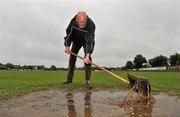 3 June 2012; Iggy Donnelly, originally from Tyrone, shovels away some surface water from the entrance to the pitch before the game. Connacht GAA Football Senior Championship Quarter-Final, London v Leitrim, Emerald Park, Ruislip, London. Picture credit: Diarmuid Greene / SPORTSFILE