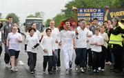 6 June 2012; Medallist in the 1992 Barcelona Olympic Games Wayne McCullough  runs with the Olympic Flame during the hand over of the Olympic Torch at the border of Northern Ireland and the Republic of Ireland. Carrickarnon, Co. Louth. Picture credit: Oliver McVeigh / SPORTSFILE