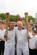 6 June 2012; Medallists in the 1992 Barcelona Olympic Games, Wayne McCullough, left, and Michael Carruth, after performing a &quot;torch Kiss&quot; of the Olympic Flame during the hand over of the Olympic Torch at the border of Northern Ireland and the Republic of Ireland. Carrickarnon, Co. Louth. Picture credit: Oliver McVeigh / SPORTSFILE