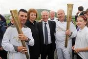 6 June 2012; Medallists in the 1992 Barcelona Olympic Games, Wayne McCullough, left, and Michael Carruth, alongside Caral Ni Chuilin, MLA, Sports Minister, Departure of Culture, Arts and Leisure, Northern Ireland, and Michael Ring TD, Minister of State for Tourism and Sport, after performing a &quot;torch Kiss&quot; of the Olympic Flame during the hand over of the Olympic Torch at the border of Northern Ireland and the Republic of Ireland. Carrickarnon, Co. Louth. Picture credit: Oliver McVeigh / SPORTSFILE