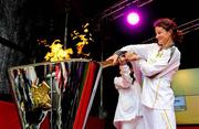 6 June 2012; Irish Olympian & 5000m silver medallist Sonia O'Sullivan and her daughter Sophie, age 10, light the cauldron with the Olympic Flame during the London 2012 Olympic Torch Relay. St. Stephen's Green, Dublin. Picture credit: Brian Lawless / SPORTSFILE