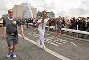 6 June 2012; Former Republic of Ireland footballer Paul McGrath with the Olympic Flame on Samuel Beckett Bridge during the London 2012 Olympic Torch Run in Ireland. Samuel Beckett Bridge, Dublin. Picture credit: Diarmuid Greene / SPORTSFILE