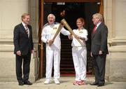6 June 2012; Gold Medalist in the 1956 Olympic Games, Ronnie Delany, and Bridget Taylor, mother of Olympic Boxer Katie Taylor, with their Olympic Flames alongside An Taoiseach Enda Kenny T.D., left, and Tánaiste Eamon Gilmore, T.D., right, outside Government Buildings during the London 2012 Olympic Torch Relay through the streets of Dublin. Merrion Square, Dublin. Picture credit: Barry Cregg / SPORTSFILE