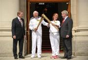 6 June 2012; Gold Medalist in the 1956 Olympic Games, Ronnie Delany, and Bridget Taylor, mother of Olympic Boxer Katie Taylor, with their Olympic Flames alongside An Taoiseach Enda Kenny T.D., left, and Tánaiste Eamon Gilmore, T.D., right, outside Government Buildings during the London 2012 Olympic Torch Relay through the streets of Dublin. Merrion Square, Dublin. Picture credit: Barry Cregg / SPORTSFILE
