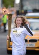 6 June 2012; Torchbearer Áine Holden, from Ballon/Rathoe, Co. Carlow, is the winner of a HSE Community Games nationwide draw to represent over 50,000 children and volunteers who compete in the Community Games each year. She is a student at Gaelscoil Carlow and a keen camogie and football player. Aine is the youngest torch bearer in the Relay, with the Olympic Flame during the London 2012 Olympic Torch Relay through the streets of Dublin. Picture credit: Ray McManus / SPORTSFILE
