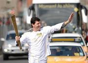 6 June 2012; Torchbearer Shane Horgan, who recently retired through injury from rugby football following a superb career as a centre and winger that included 65 caps for Ireland, being part of three Triple Crown winning sides and gaining a British and Irish Lions tour spot. Now a media pundit, he is one of the most popular figures in Irish sport and a legend in Leinster rugby, where he racked up 207 caps for his province including a European Cup victory, with the Olympic Flame during the London 2012 Olympic Torch Relay through the streets of Dublin. Custom House Quay, Dublin. Picture credit: Ray McManus / SPORTSFILE