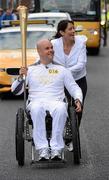 6 June 2012; Mark Pollock, from Hollywood, Co. Down, with his partner Simone George. Mark is a double medallist in rowing in the Commonwealth Games and is unbroken by the loss of his sight at 22 and a paralysing fall 13 years later. A Trinity College Dublin graduate, Mark has competed against professional explorers like Sir Ranulph Fiennes, Olympic gold medalists and special forces personnel; all able-bodied athletes For the last decade, the blind adventure athlete has run a marathon at The North Pole, raced through the desert lowlands of the Syrian African Rift Valley to the Dead Sea and competed at high-altitude in the Everest Marathon. After a life threatening fall last year, Mark is paralysed from the waist , with the Olympic Flame during the London 2012 Olympic Torch Relay through the streets of Dublin. Grand Canal Theatre, Dublin. Picture credit: Ray McManus / SPORTSFILE