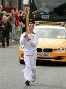 6 June 2012; Torchbearer Gary O'Brien, from Portmarnock, Dublin, who represented Ireland at the 2011 Special Olympics World Summer Games, winning a silver medal in the 400 metres. Gary is a big lover of sport; he plays basketball and football as well as athletics. Gary was the winner of the Fingal Independent Young Sport Star of the Year 2011, with the Olympic Flame during the London 2012 Olympic Torch Relay through the streets of Dublin. Clanbrassil Street, Dublin. Picture credit: Ray McManus / SPORTSFILE