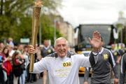6 June 2012; Torchbearer Ronnie Delany, from Arklow, is Ireland’s most famous Olympian, winning the gold medal at the 1956 Olympic Games in Melbourne. He went on to represent Ireland in the 1960 Summer Olympics in Rome. He continued his running career in North America winning four successive AAU titles in the mile and broke the world indoor mile record on three occasions. He is one of Ireland’s best sporting ambassadors and was made a Freeman of the City of Dublin in 2006, with the Olympic Flame during the London 2012 Olympic Torch Relay through the streets of Dublin. Merrion Square West, Dublin. Picture credit: Ray McManus / SPORTSFILE
