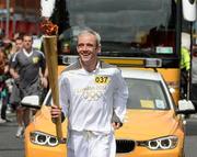 6 June 2012; Torchbearer Ruby Walsh, from Co. Kildare, is Ireland’s most celebrated jump jockey and a legend in National Hunt racing. With over 1,900 winners in a star-studded career to date, Ruby continues to win honours in Britain and Ireland and is a superb ambassador for the sport and his country, with the Olympic Flame during the London 2012 Olympic Torch Relay through the streets of Dublin. Nassau Street, Dublin. Picture credit: Ray McManus / SPORTSFILE