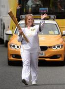 6 June 2012; Torchbearer Pamela Lacken, from Ballina, Co. Mayo, and currently living in Ennis, Co. Clare, is one of 200 winners from over 1,700 nominations in the Lloyds Banking Group’s ‘Making a Difference’ Awards campaign in the UK. She travelled to Athens in 2011 as part of the Special Olympics Ireland team of volunteers at the World Summer Games and also volunteers with the Ennis Eagles Bowling club, with the Olympic Flame during the 2012 Olympic Torch Relay through the streets of Dublin. Picture credit: Ray McManus / SPORTSFILE