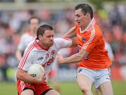 10 June 2012; Mark Donnelly, Tyrone  in action against Andy Mallon, Armagh. Ulster GAA Football Senior Championship, Quarter-Final, Armagh v Tyrone, Morgan Athletic Grounds, Armagh. Picture credit: Oliver McVeigh / SPORTSFILE
