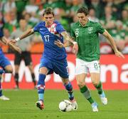 10 June 2012; Keith Andrews, Republic of Ireland, in action against Mario Mandžukic, Croatia. EURO2012, Group C, Republic of Ireland v Croatia, Municipal Stadium Poznan, Poznan, Poland. Picture credit: David Maher / SPORTSFILE