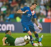10 June 2012; Mario Mandžukic, Croatia, is tackled by Keith Andrews, Republic of Ireland. EURO2012, Group C, Republic of Ireland v Croatia, Municipal Stadium Poznan, Poznan, Poland. Picture credit: David Maher / SPORTSFILE