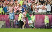 10 June 2012; Jonathan Walters, Republic of Ireland, helps a steward apprehend a Croatian pitch invader during the final minutes of the game. EURO2012, Group C, Republic of Ireland v Croatia, Municipal Stadium Poznan, Poznan, Poland. Picture credit: David Maher / SPORTSFILE