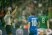 10 June 2012; Referee Bjorn Kuipers shows the yellow card to Keith Andrews, Republic of Ireland. EURO2012, Group C, Republic of Ireland v Croatia, Municipal Stadium Poznan, Poznan, Poland. Picture credit: David Maher / SPORTSFILE