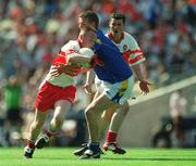 1 September 2002; Ciaran Mullan of Derry is tackled by Noel Farrell of Longford during the All-Ireland Minor Football Championship Semi-Final match between Derry and Longford at Croke Park in Dublin. Photo by Ray McManus/Sportsfile