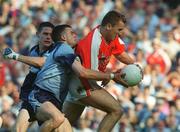1 September 2002; Paddy McKeever of Armagh goes past the tackle of Paul Casey, centre, and Dublin goalkeeper Stephen Cluxton, to score a goal during the Bank of Ireland All-Ireland Senior Football Championship Semi-Final match between Armagh and Dublin at Croke Park in Dublin. Photo by Pat Murphy/Sportsfile