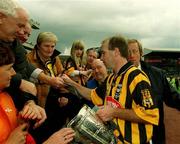 8 September 2002; Kilkenny's DJ Carey, with the Liam MacCarthy cup, signs autographs for fans following victory in the Guinness All-Ireland Senior Hurling Championship Final match between Kilkenny and Clare at Croke Park in Dublin. Photo by Aoife Rice/Sportsfile
