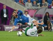 18 June 2012; Daniele De Rossi, Italy, is tackled by Kevin Doyle, Republic of Ireland. EURO2012, Group C, Republic of Ireland v Italy, Municipal Stadium Poznan, Poznan, Poland. Picture credit: David Maher / SPORTSFILE