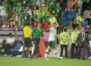 18 June 2012; Keith Andrews, Republic of Ireland, points to the referee after receiving a red card, for a second bookable offence. EURO2012, Group C, Republic of Ireland v Italy, Municipal Stadium Poznan, Poznan, Poland. Picture credit: Brendan Moran / SPORTSFILE
