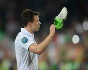 18 June 2012; Sean St. Ledger, Republic of Ireland, prepares to throw his boots into the crowd at the end of the game. EURO2012, Group C, Republic of Ireland v Italy, Municipal Stadium Poznan, Poznan, Poland. Picture credit: David Maher / SPORTSFILE