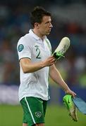 18 June 2012; Sean St. Ledger, Republic of Ireland, prepares to throw his boots into the crowd at the end of the game. EURO2012, Group C, Republic of Ireland v Italy, Municipal Stadium Poznan, Poznan, Poland. Picture credit: David Maher / SPORTSFILE