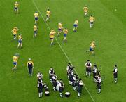 17 June 2012; The Clare team warm-up alongside the Sean Treacy Pipe band. Munster GAA Hurling Senior Championship Semi-Final, Clare v Waterford, Semple Stadium, Thurles, Co. Tipperary. Picture credit: Stephen McCarthy / SPORTSFILE