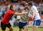 24 June 2012; Dessie Mone, Monaghan, assisted by team mate Darren Hughes, is tackled by Ambrose Rodgers, Down. Ulster GAA Football Senior Championship Semi-Final, Down v Monaghan, Morgan Athletic Grounds, Armagh. Picture credit: Oliver McVeigh / SPORTSFILE