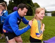 16 September 2017; Former Roscommon GAA footballer, Cathal Cregg and current Roscommon GAA footballer Niall Kilroy joined runners at the Lough Key parkrun where Vhi hosted a special event to celebrate their partnership with parkrun Ireland. Cathal Cregg and Niall Kilroy were on hand to lead the warm up for parkrun participants before completing the 5km course alongside newcomers and seasoned parkrunners alike. Vhi provided walkers, joggers, runners and volunteers at Lough Key parkrun with a variety of refreshments in the Vhi Relaxation Area at the finish line. A qualified physiotherapist was also available to guide participants through a post event stretching routine to ease those aching muscles. parkruns take place over a 5km course weekly, are free to enter and are open to all ages and abilities, providing a fun and safe environment to enjoy exercise. To register for a parkrun near you visit www.parkrun.ie. New registrants should select their chosen event as their home location. You will then receive a personal barcode which acts as your free entry to any parkrun event worldwide. Pictured is current Roscommon GAA footballer Niall Kilroy signing a jersey for Rachel Sweeney, age 9, from Boyle, Co. Roscommon, at Lough Key, Co. Roscommon. Photo by Seb Daly/Sportsfile